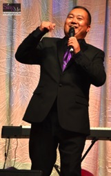 SingMe Founder & Musical Director, Billy Hui, chats to the audience during The SingMe Variety Show 2016